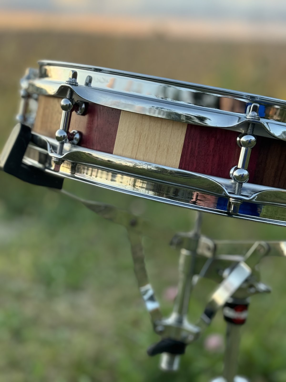 Cherry stave snare drum with brass hardware and an Evans HD Dry head, shot on white