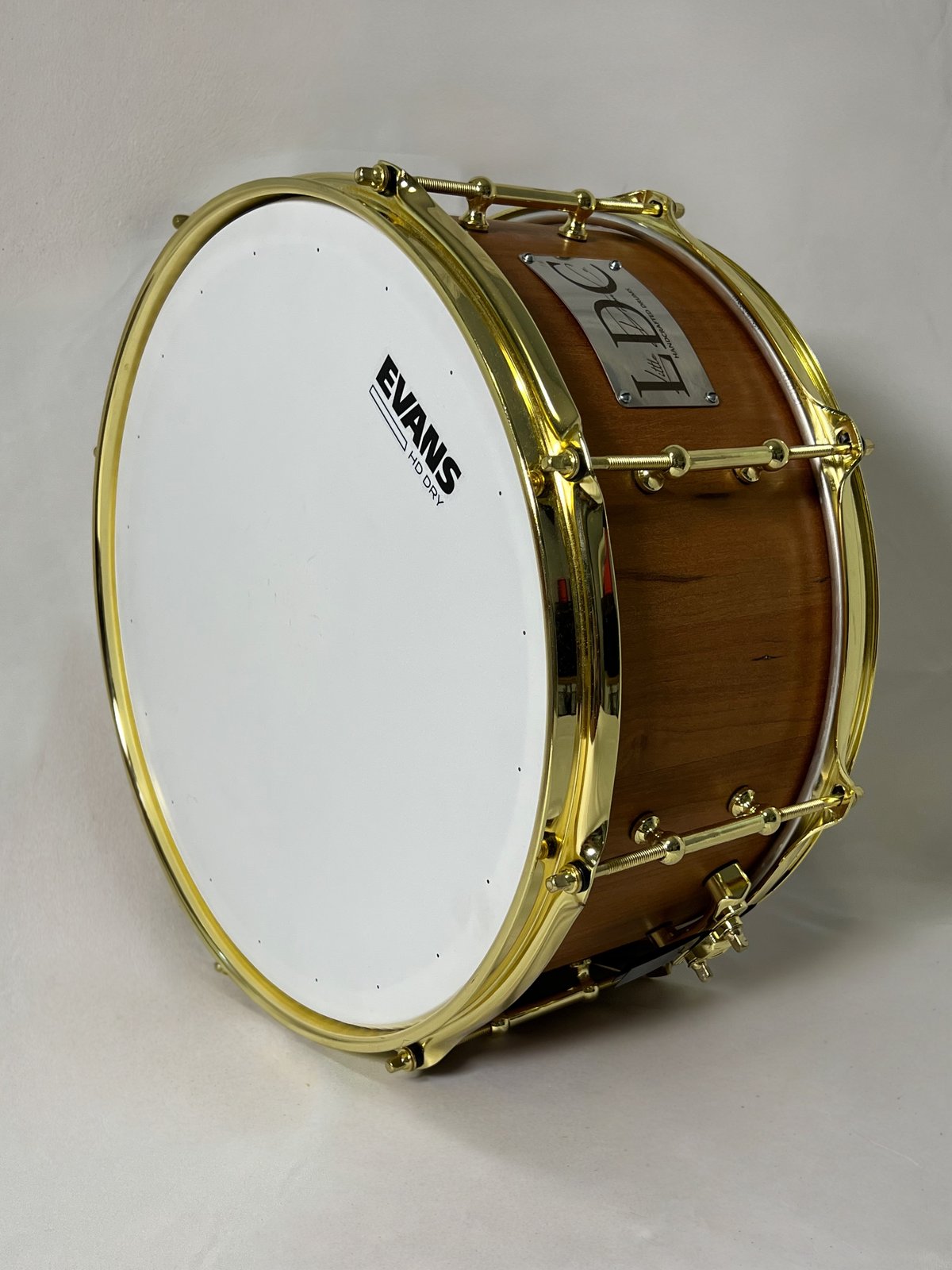 Purpleheart and maple stave snare drum with chrome hoops, alternating purple and blonde staves